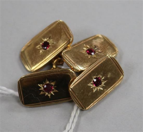 A pair of 9ct gold cufflinks with inset red stone.